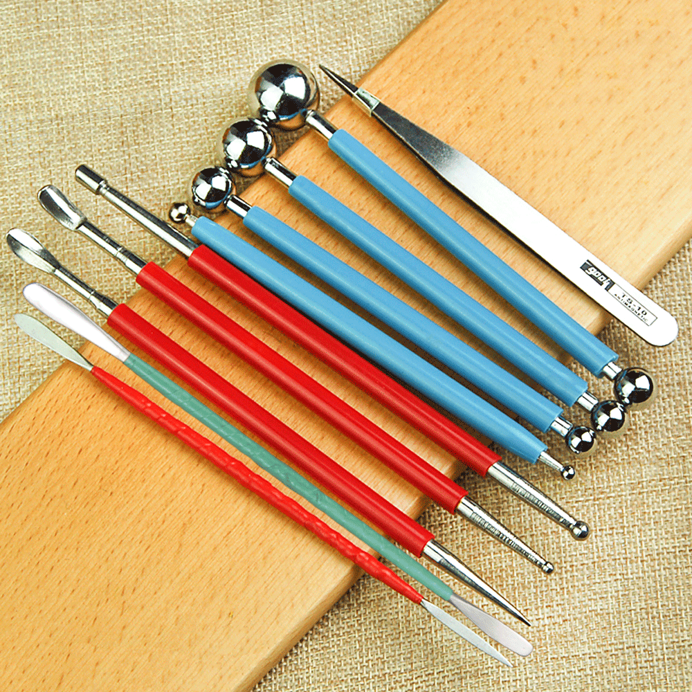 Hand holding a stainless steel carving knife from the Multi-Purpose Sculpting Tools set, demonstrating precision for sugar art details