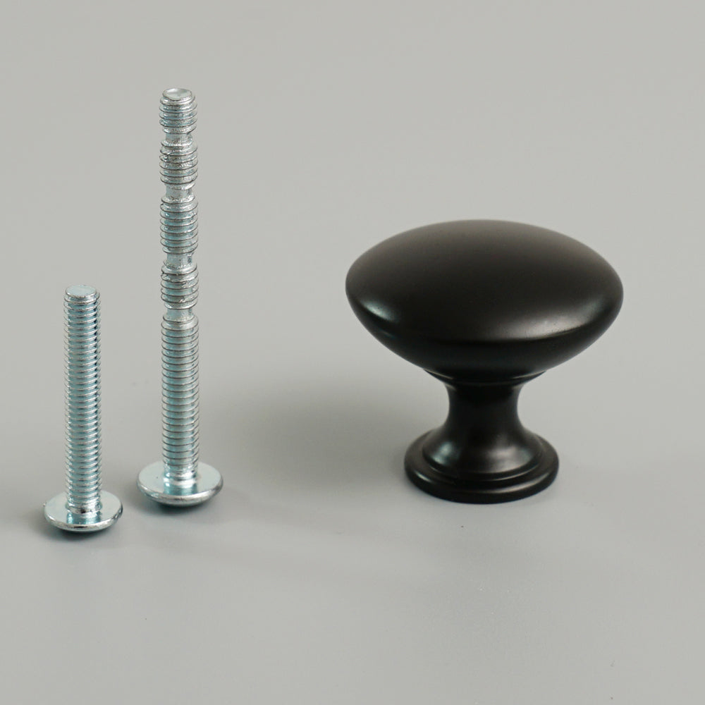 Black zinc alloy single hole drawer handle installed on drawer