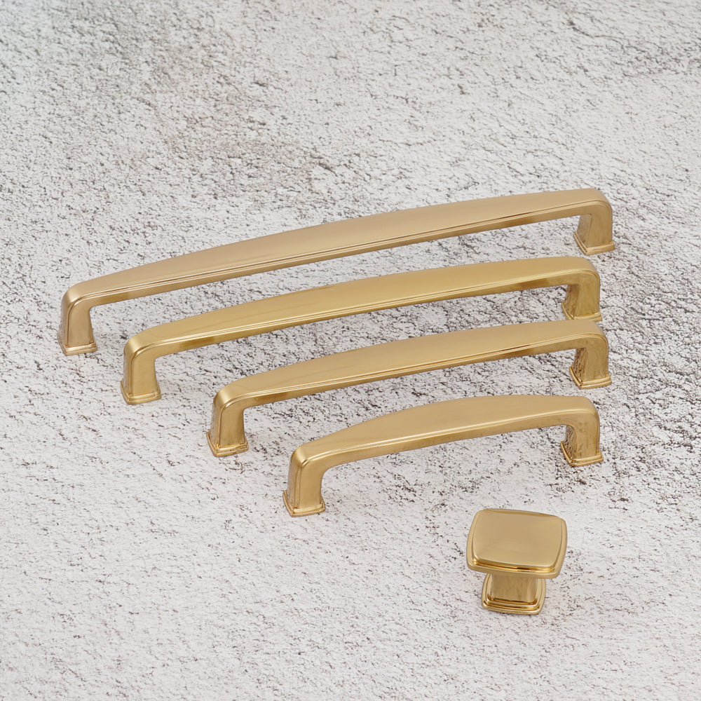 Close-up of brushed champagne bronze cabinet handle surface.