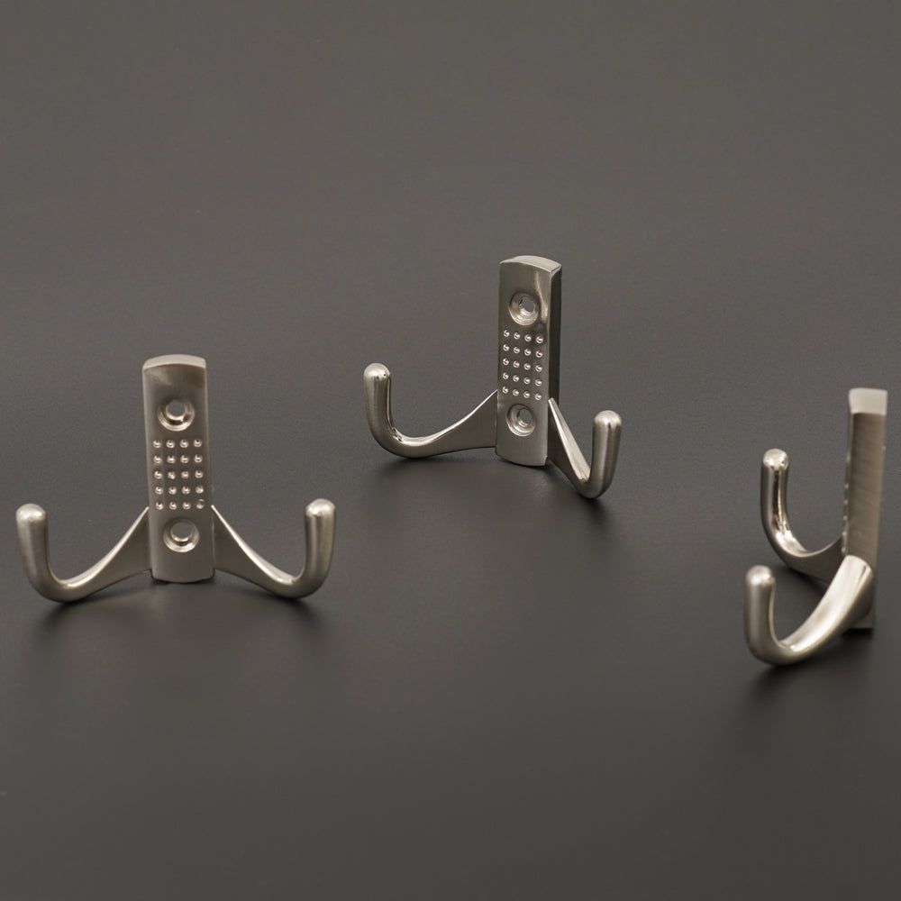 Satin nickel coat hooks installed on a bedroom door.