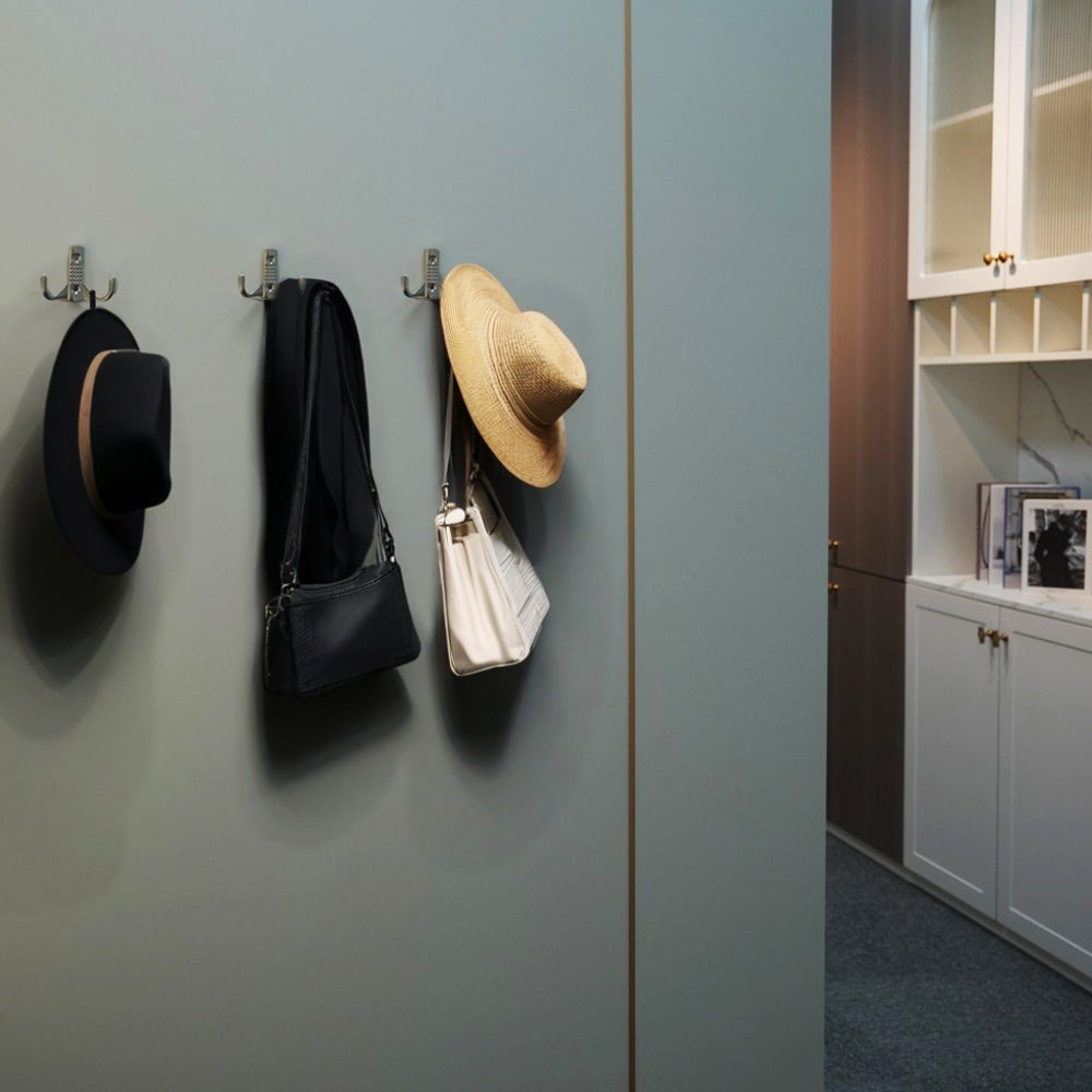 Side view of a satin nickel coat hook showing smooth curved design.