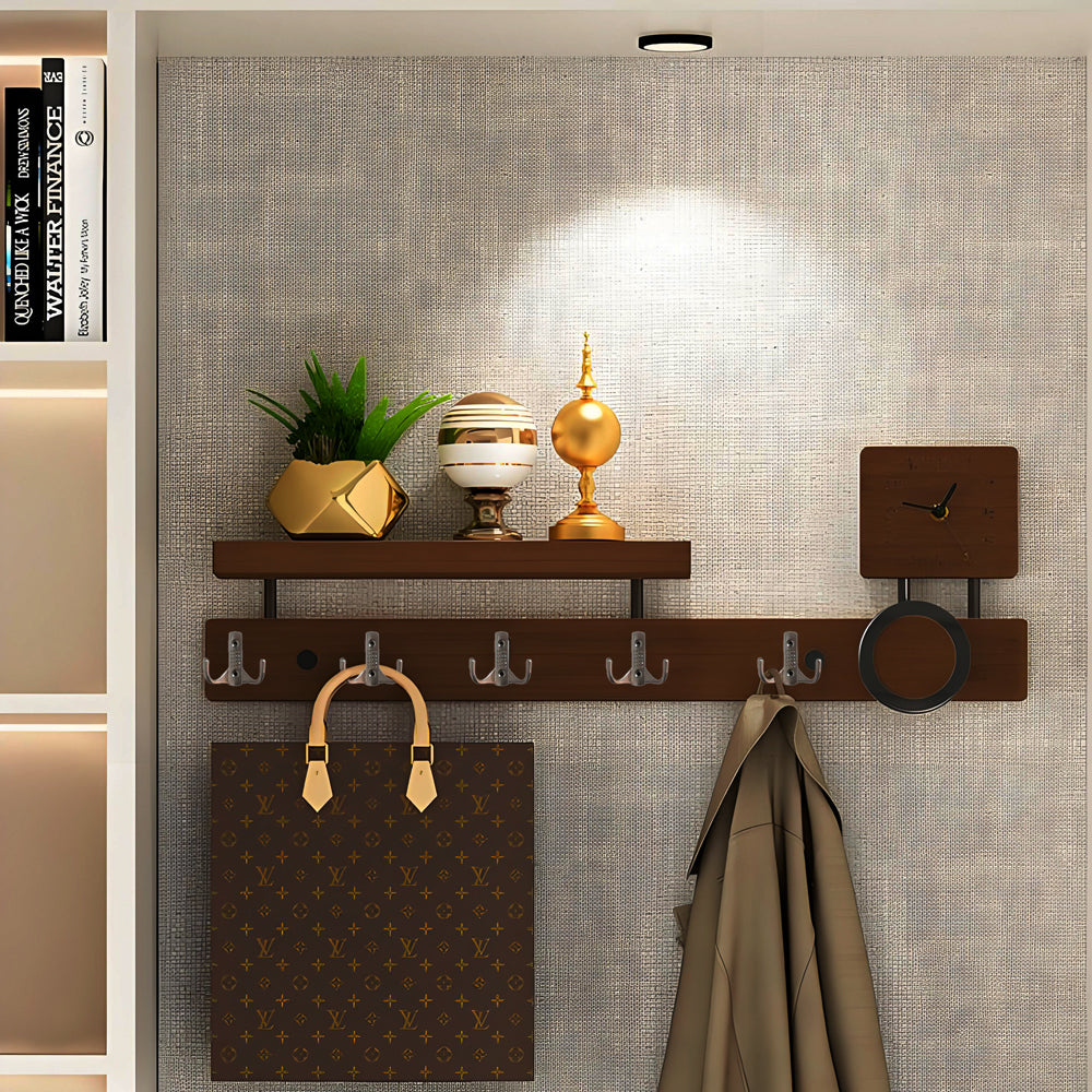 Satin nickel wall-mounted coat hook attached to a wooden surface.